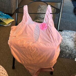 Dusty rose colored swim suit with sheer inserts on top and sides. Low back